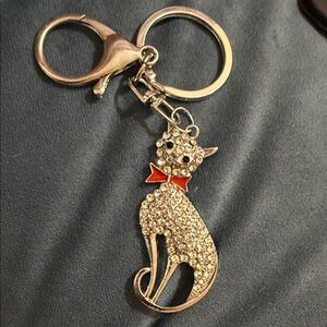 Elegant Silver Cat Keychain with Red Bow